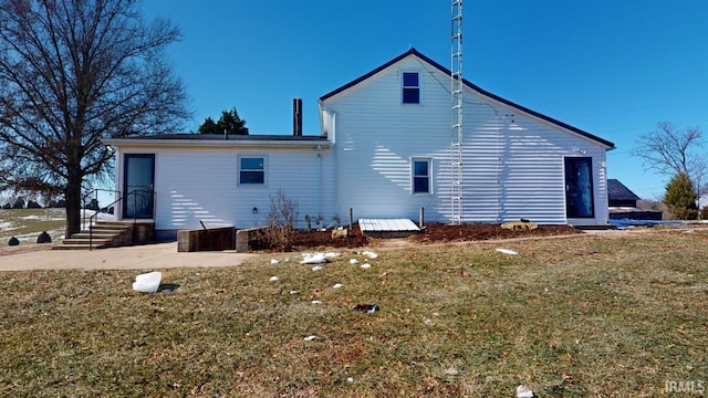 back of house with a yard and a patio