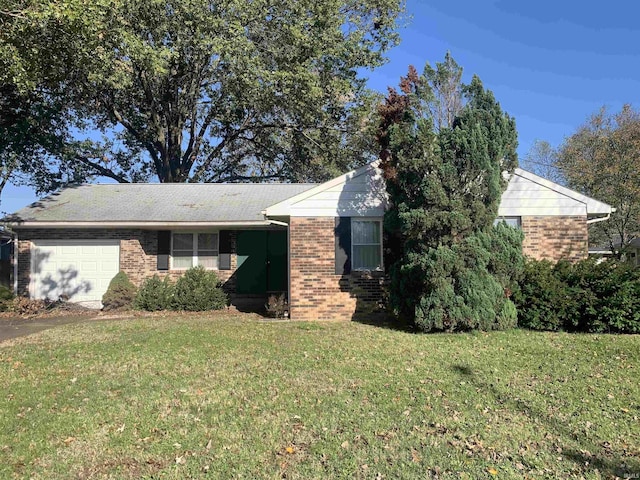 view of front of house with a garage and a front yard