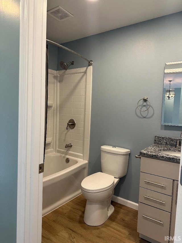 full bathroom with wood-type flooring, toilet, shower / washtub combination, and vanity