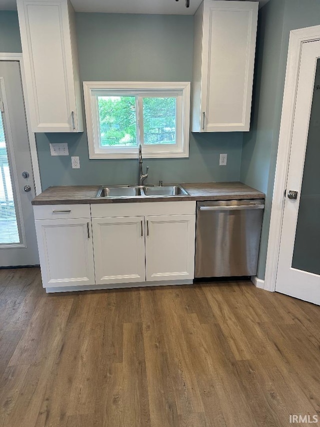 kitchen featuring dishwasher, sink, white cabinets, and light hardwood / wood-style flooring