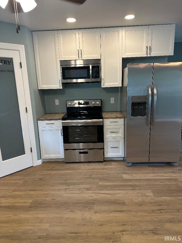 kitchen featuring white cabinetry, appliances with stainless steel finishes, and light hardwood / wood-style flooring