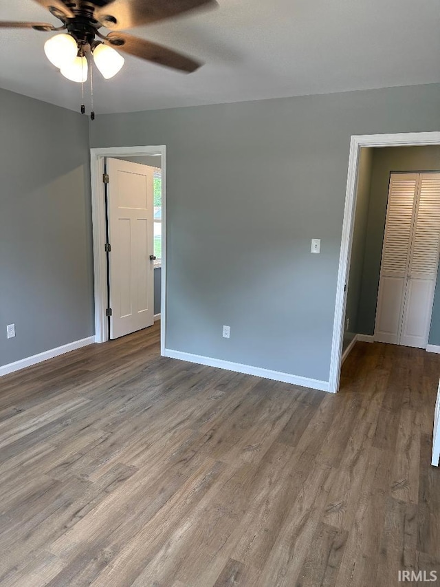 empty room with hardwood / wood-style flooring and ceiling fan