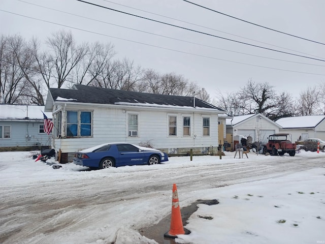 view of front facade with an outbuilding and a garage