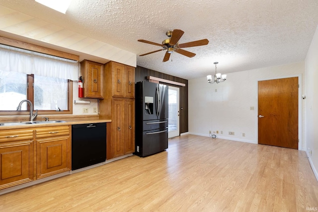 kitchen with sink, fridge with ice dispenser, a textured ceiling, black dishwasher, and pendant lighting