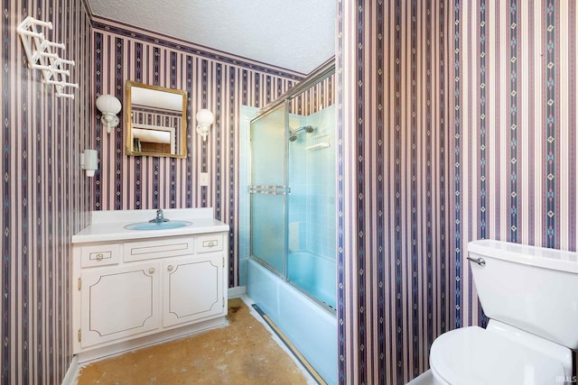 full bathroom featuring vanity, enclosed tub / shower combo, toilet, and a textured ceiling