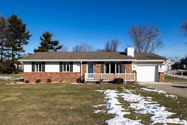 ranch-style house with a yard, a garage, and covered porch