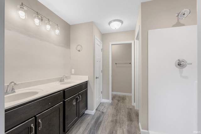 bathroom featuring vanity, wood-type flooring, and a textured ceiling