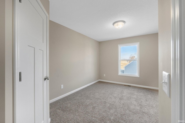 unfurnished room featuring carpet