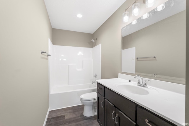 full bathroom with wood-type flooring, toilet, shower / bathing tub combination, and vanity