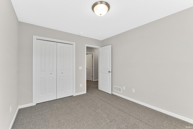 unfurnished bedroom featuring carpet floors and a closet