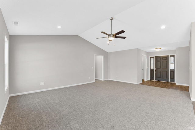 unfurnished living room with ceiling fan, dark carpet, and a wealth of natural light