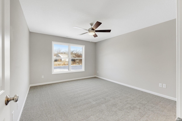 spare room featuring light colored carpet and ceiling fan