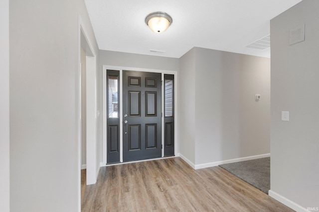 entryway with light hardwood / wood-style flooring