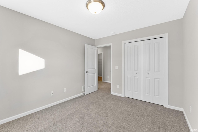 unfurnished bedroom with carpet flooring and a closet