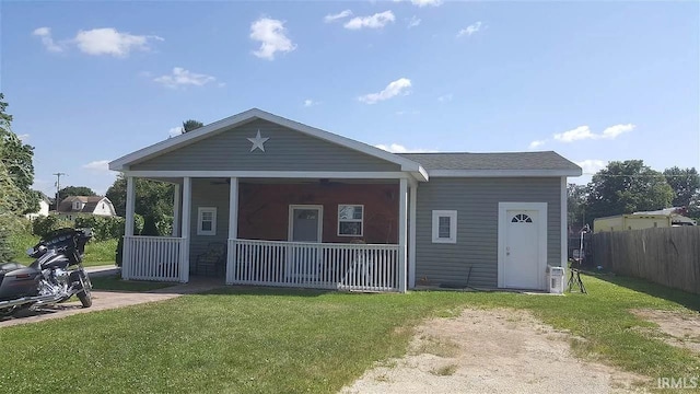 back of property with a porch and a lawn