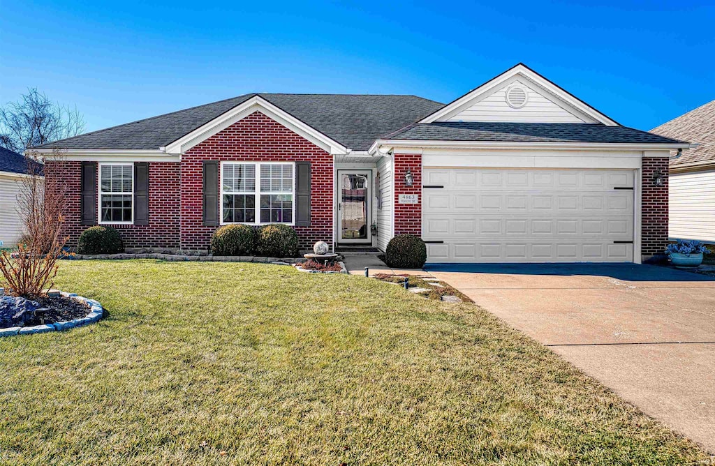 ranch-style house featuring a garage and a front yard