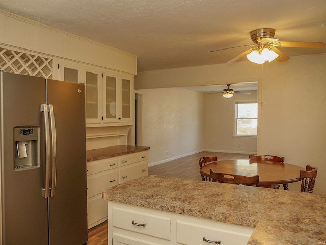 kitchen featuring dark wood-type flooring, white cabinets, and stainless steel fridge with ice dispenser