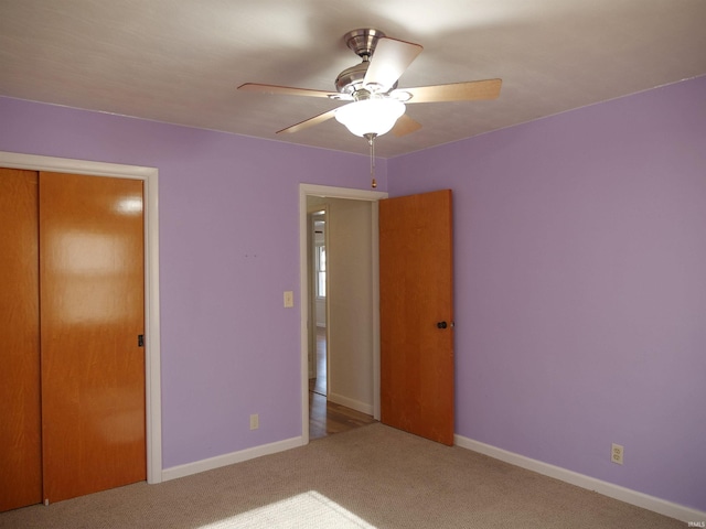 unfurnished bedroom featuring carpet floors, a closet, and ceiling fan