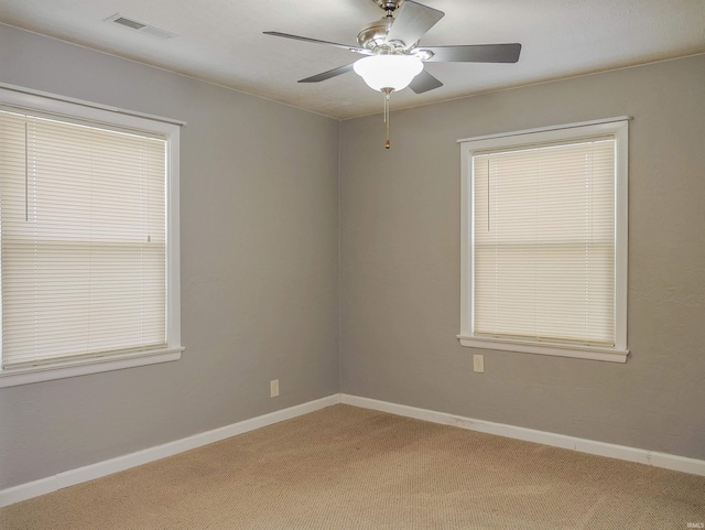 spare room featuring ceiling fan and carpet flooring