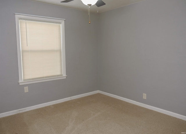 spare room featuring ceiling fan and carpet floors