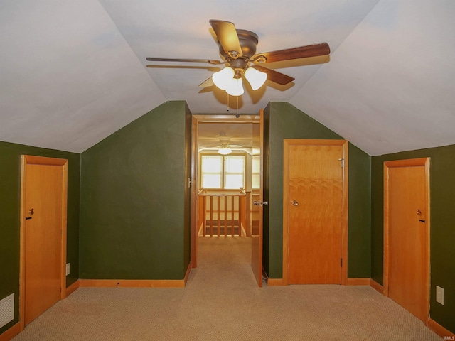 additional living space featuring lofted ceiling, light carpet, and ceiling fan