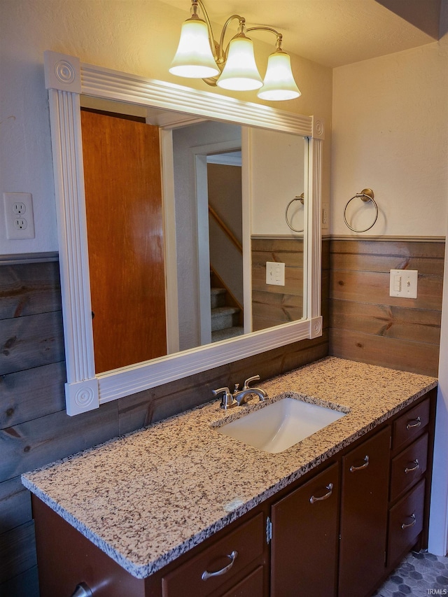 bathroom with vanity and wood walls