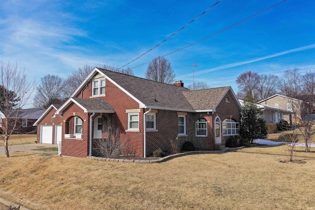 view of front of home with a garage and a front lawn