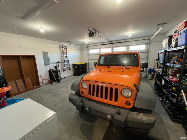 garage featuring a garage door opener and electric panel