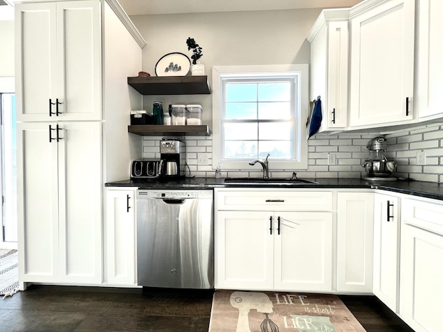 kitchen with sink, stainless steel dishwasher, dark hardwood / wood-style floors, white cabinets, and backsplash