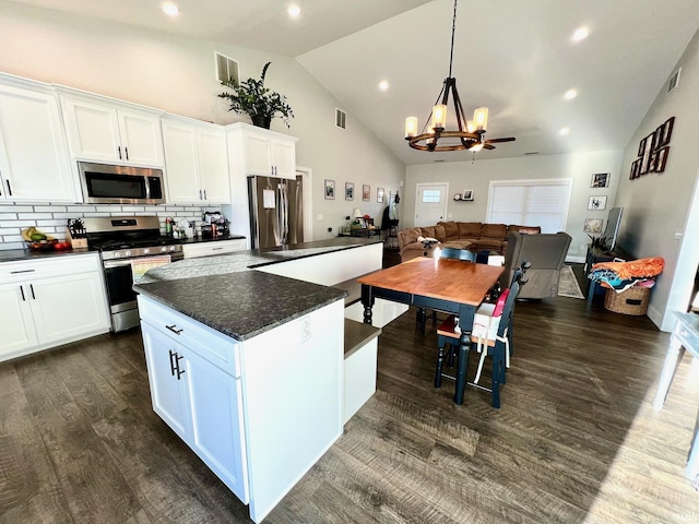 kitchen with white cabinetry, decorative backsplash, dark wood-type flooring, and stainless steel appliances