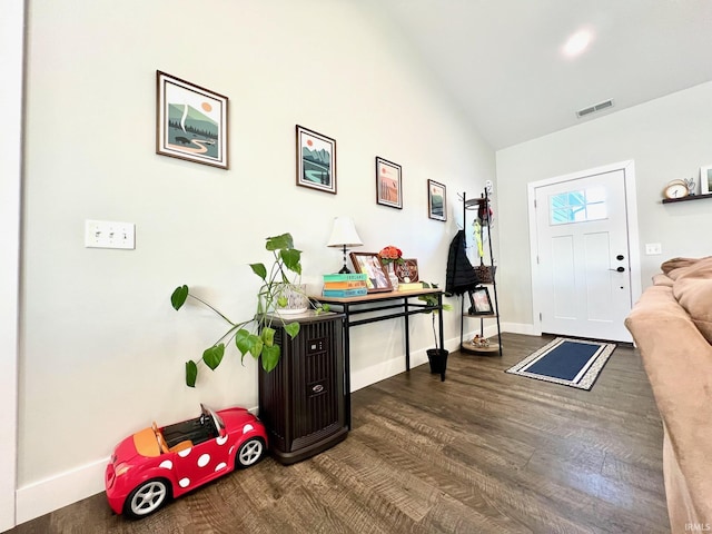 entryway featuring dark hardwood / wood-style flooring and high vaulted ceiling