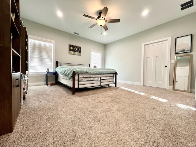 bedroom featuring ceiling fan and carpet