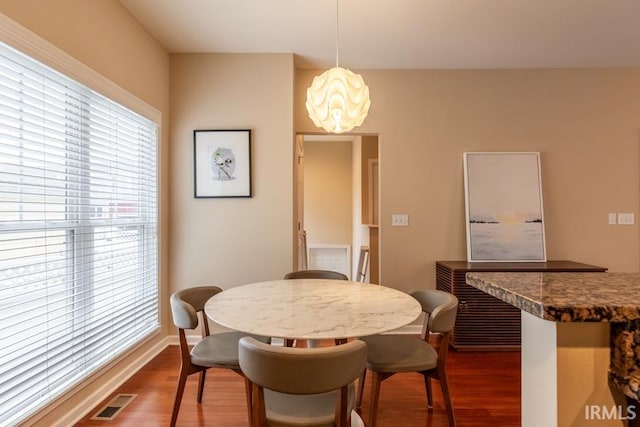 dining area featuring hardwood / wood-style floors and a notable chandelier