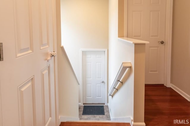 stairway featuring wood-type flooring