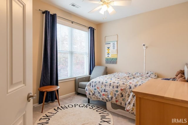 carpeted bedroom featuring multiple windows and ceiling fan