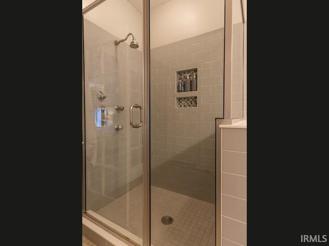 bathroom featuring a shower with shower door