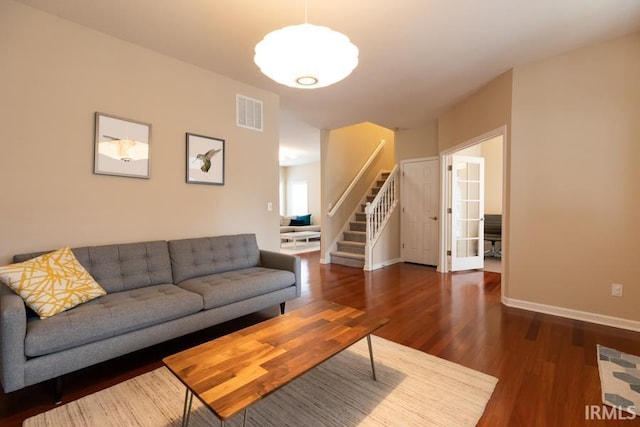 living room with dark hardwood / wood-style flooring