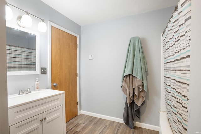 bathroom with hardwood / wood-style flooring and vanity