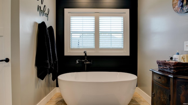 bathroom with tile patterned flooring and a washtub