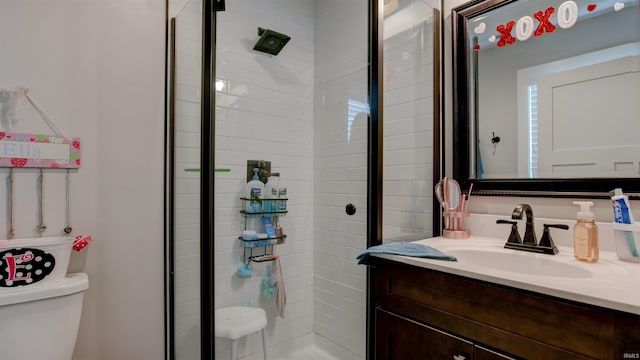 bathroom featuring vanity, an enclosed shower, and toilet