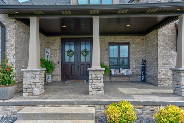 view of exterior entry with a porch