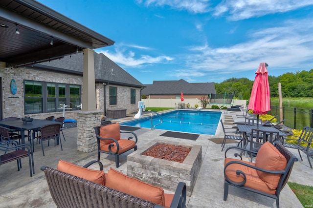 view of pool featuring a patio area and an outdoor fire pit