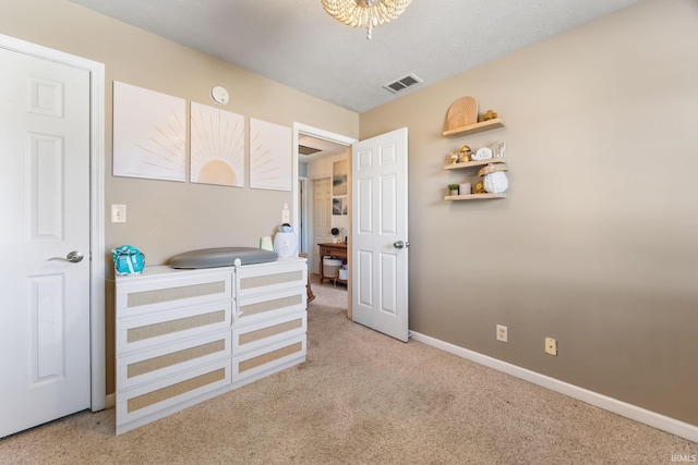 bedroom featuring carpet floors and a textured ceiling