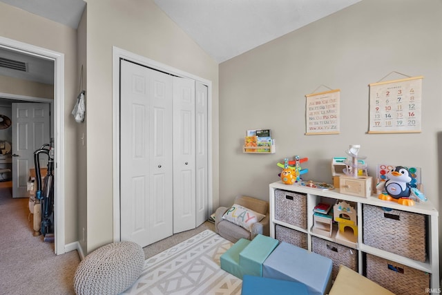 playroom featuring lofted ceiling and light carpet