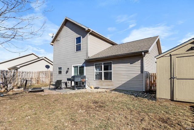 rear view of house with a patio area, a lawn, and a storage unit