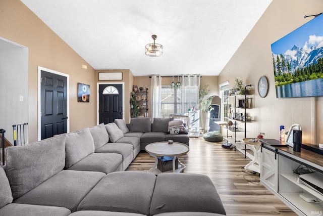 living room featuring vaulted ceiling and light hardwood / wood-style floors