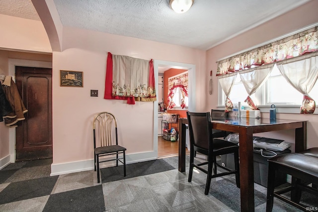 dining room with a textured ceiling