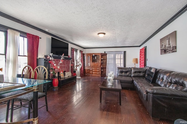 living room with dark hardwood / wood-style flooring, ornamental molding, and a textured ceiling