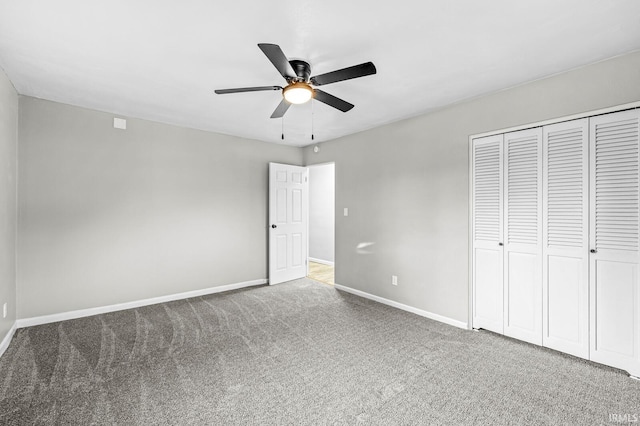 unfurnished bedroom featuring carpet flooring, ceiling fan, and a closet