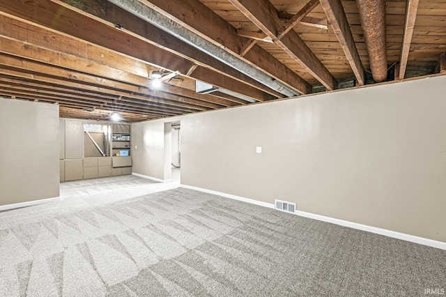 basement featuring light colored carpet